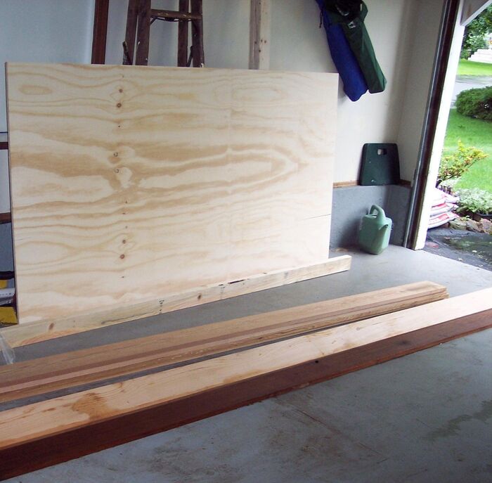 I built a 17-foot composite kayak. This is what it started as. There is plywood and a straight 2x4 for the strongback, and a good supply of western redcedar.