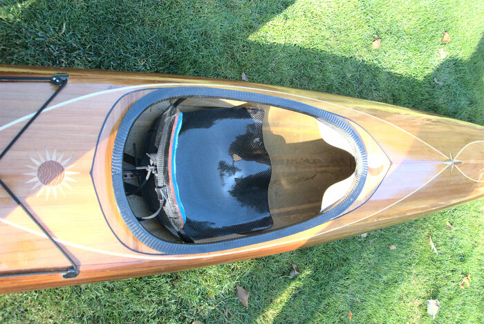 Here we can see the coaming and seat assembly, as well as the sun (behind the seat), moon (right in front of the coaming) and star (intersection of two poplar curves) inlays